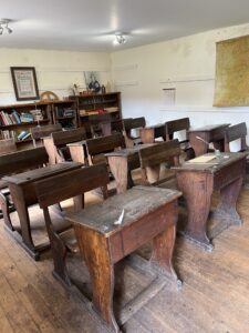 Old fashioned school class room with wooden desks and chairs