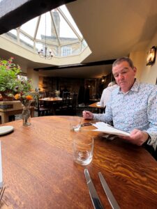 Man sitting at table in pub looking at menu