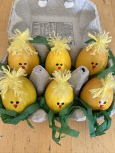 Decorated Easter eggs in a cardboard carton