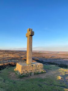 Ana Cross at top of the Moors in sunlight