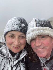 Woman and Man in hats with snow sticking to them.