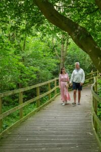 Man and woman walking on board walk at Danby Lodge