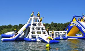 Children in helmets playing on an inflatable water slide at the North Yorkshire Waterpark