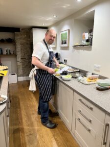 Chef Dan Graham preparing dinner for guests in the Long Barn