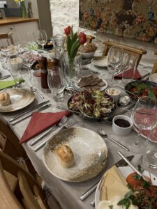 Dining Room Table set for dinner with flowers, candles and food