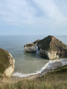 Craggy white cliffs with tide in and unusual rock formation