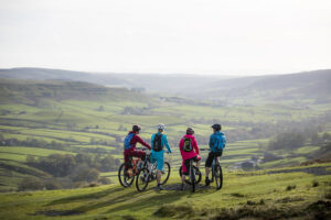 4 cyclists on hill top looking down into Rosedale 