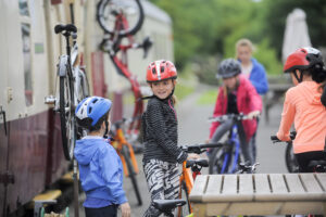 two children in bike helmets getting ready for a cycle adveture