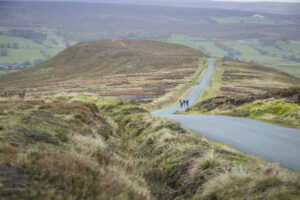 3 cyclists cycling donw hill on North York Moors