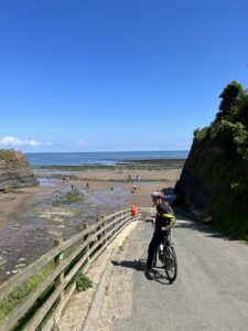 Man on bike leading down to beach