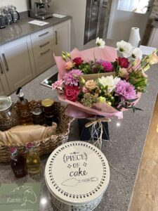 Flowers next to welcome hamper in kitchen