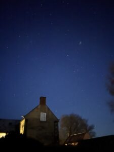 clear star lit night behing a stone farm house