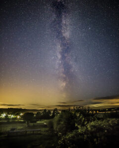 Milky way in purple sky over a small market town