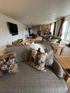 Living room with comfy sofas and wood burner. 