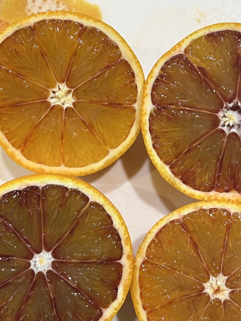 Blood oranges and oranges halved, their jewel-coloured flesh ready for marmalade making.