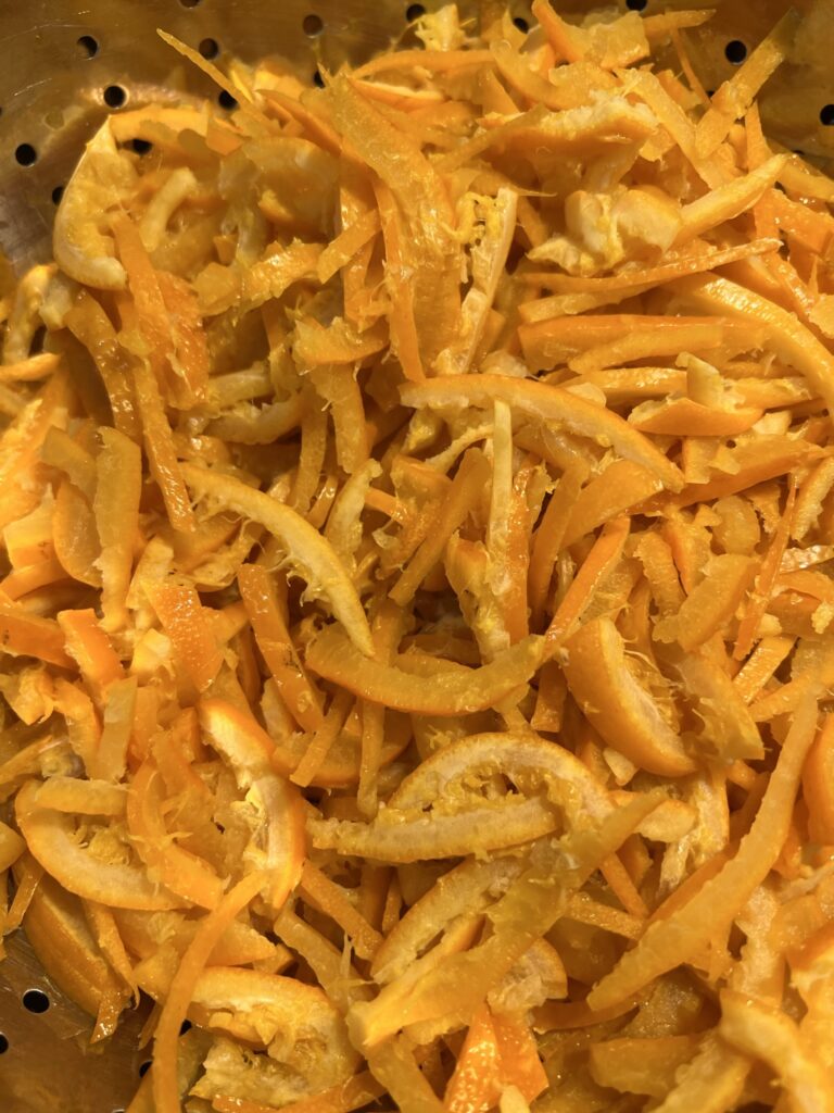 Thinly shredded citrus peel, prepared for soaking before cooking marmalade.