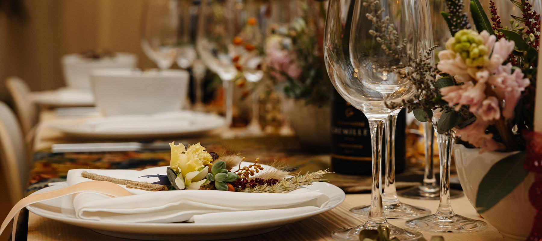 Close-up of intimate wedding table styling with glassware, floral details and place settings at the Long Barn in North York Moors